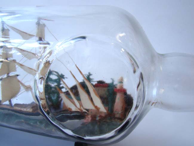 A large Ship in a bottle, the background featuring a coastal town with trees and a lighthouse, American circa 1940 — image 3